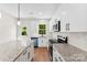 Well-lit kitchen with island, stainless steel appliances, granite countertops, and white subway tile backsplash at 1017 S Main St, Granite Quarry, NC 28146