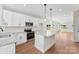 Bright open kitchen with an island, stainless steel appliances, and plenty of natural light at 1017 S Main St, Granite Quarry, NC 28146