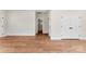 Spacious room with wood floors and access to bathroom and other rooms at 1017 S Main St, Granite Quarry, NC 28146