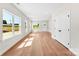 Bright, open-concept living room with wood floors and many windows at 1017 S Main St, Granite Quarry, NC 28146
