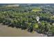 An aerial view of the house nestled among lush trees by the lakefront at 3770 Buck Point Rd, Catawba, NC 28609