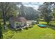 Aerial view of a home with a spacious lawn, a patio, a storage shed, and a relaxing above ground pool at 3770 Buck Point Rd, Catawba, NC 28609