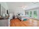 Tranquil bedroom featuring hardwood floors, neutral walls, and double doors to the outdoor deck with backyard views at 3770 Buck Point Rd, Catawba, NC 28609
