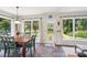 Bright dining area with a wooden table, green chairs, and scenic backyard views at 3770 Buck Point Rd, Catawba, NC 28609