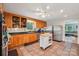 Well-lit kitchen featuring wooden cabinets, stainless steel appliances, tile flooring and a moveable kitchen island at 3770 Buck Point Rd, Catawba, NC 28609