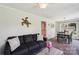 Cozy living space with hardwood floors, a dark couch, and an adjacent dining area at 3770 Buck Point Rd, Catawba, NC 28609