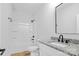 Bright bathroom with a tub, shower, vanity, granite countertop, and modern fixtures at 7 S Coulter Ave, Newton, NC 28658