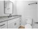 Modern bathroom featuring granite counters, a sleek mirror, and neutral decor at 7 S Coulter Ave, Newton, NC 28658