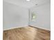 Clean, airy bedroom with hardwood floors and a large window offering a green view at 7 S Coulter Ave, Newton, NC 28658