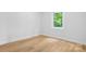 Bright bedroom featuring hardwood floors, white walls, and a window with natural light at 7 S Coulter Ave, Newton, NC 28658