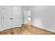 Spacious bedroom with hardwood floors, double doors, and a view into the next room at 7 S Coulter Ave, Newton, NC 28658