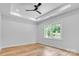 Serene bedroom with tray ceiling, recessed lighting, wood floors, and a large window at 7 S Coulter Ave, Newton, NC 28658