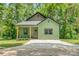 Charming cottage-style home featuring a green exterior, covered porch, and well-manicured lawn at 7 S Coulter Ave, Newton, NC 28658