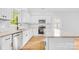 Modern kitchen with white cabinetry, granite counters, stainless steel appliances, and a center island at 7 S Coulter Ave, Newton, NC 28658