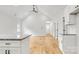 Open concept kitchen with wood flooring, granite counters, white cabinets and stainless appliances at 7 S Coulter Ave, Newton, NC 28658