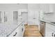 Elegant kitchen with granite counters, stainless steel appliances, white cabinets, and wood-look floors at 7 S Coulter Ave, Newton, NC 28658