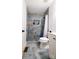 This bathroom boasts a glass enclosed shower, gold fixtures, and blue tile at 9232 Chislehurst Rd, Mint Hill, NC 28227