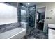 Modern bathroom with blue marble tile, a glass-enclosed shower, and a soaking tub at 9232 Chislehurst Rd, Mint Hill, NC 28227