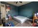 Simple bedroom with hardwood floors and blue walls, featuring a twin bed at 9232 Chislehurst Rd, Mint Hill, NC 28227