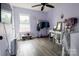 Bright bedroom with a ceiling fan, natural light, a desk, and ample closet space for storage and organization at 9232 Chislehurst Rd, Mint Hill, NC 28227