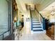Inviting foyer with tile flooring, staircase with blue accents, and elegant decor at 9232 Chislehurst Rd, Mint Hill, NC 28227
