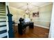Bright home office with hardwood floors, modern desk, and stylish globe chandelier at 9232 Chislehurst Rd, Mint Hill, NC 28227
