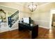 Office space with hardwood floors, a modern desk, and a stylish globe chandelier near the foyer at 9232 Chislehurst Rd, Mint Hill, NC 28227