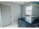Spacious laundry room with a large window, tile floor, and a newer washer and dryer at 9232 Chislehurst Rd, Mint Hill, NC 28227