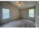 A neutral bedroom featuring carpet flooring, high ceilings, and windows with blinds at 3320 Hunting Wood Ct, Gastonia, NC 28052