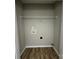Laundry room with wood-look flooring, shelving, and washer hookups at 3320 Hunting Wood Ct, Gastonia, NC 28052