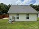 Back exterior of house features a large roof, two windows, and an AC unit on the green lawn at 3320 Hunting Wood Ct, Gastonia, NC 28052