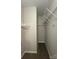 Carpeted walk-in closet with white shelving and neutral-painted walls at 3320 Hunting Wood Ct, Gastonia, NC 28052