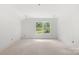 A bright and airy bedroom features a window with views of lush greenery at 4615 Yellow Poplar Ln, Concord, NC 28025