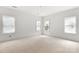 Bright bedroom features neutral walls, multiple windows, and bare flooring, offering a blank canvas for personalization at 4615 Yellow Poplar Ln, Concord, NC 28025