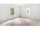 Bright room featuring two windows, white walls, and unfinished flooring for a fresh and modern appeal at 4615 Yellow Poplar Ln, Concord, NC 28025