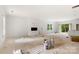 Large living room with an open fireplace and windows allowing natural light at 4615 Yellow Poplar Ln, Concord, NC 28025