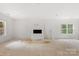 Spacious living room with large windows and a fireplace at 4615 Yellow Poplar Ln, Concord, NC 28025