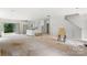 Unfinished living room featuring an open floor plan, light walls, and an exterior door at 4615 Yellow Poplar Ln, Concord, NC 28025