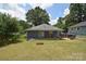 Spacious backyard featuring a patio, mature trees, and ample space for outdoor activities at 502 Allison Nw St, Concord, NC 28025