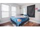 Cozy bedroom with windows, wood floors, and a floral-patterned bed at 502 Allison Nw St, Concord, NC 28025