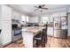 Bright kitchen featuring white cabinets, stainless steel appliances, and a charming central island at 502 Allison Nw St, Concord, NC 28025
