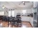 Open kitchen with white cabinets, stainless appliances, island with breakfast bar, and wood-look flooring at 502 Allison Nw St, Concord, NC 28025