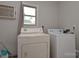 Functional laundry room with washer, dryer, and a window for natural light at 502 Allison Nw St, Concord, NC 28025