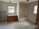 Bathroom with single vanity, enclosed shower/tub, and patterned floor at 104 Franklin St, Clover, SC 29710