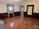 Bedroom with hardwood floors, paneled walls, and built-in shelves at 104 Franklin St, Clover, SC 29710