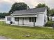 Cozy single-Gathering home with white siding, a well-maintained lawn, and a classic architectural style at 104 Franklin St, Clover, SC 29710