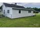 A side view of this cozy home that features light-colored siding and a spacious, green lawn at 104 Franklin St, Clover, SC 29710