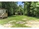 Spacious backyard with a shed, a fire pit, mature trees and a wood deck at 1354 Springwood Ln, Rock Hill, SC 29730