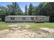 Quaint home featuring a covered front porch and spacious yard surrounded by mature trees, offering privacy at 1354 Springwood Ln, Rock Hill, SC 29730