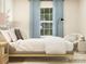 Stylish bedroom showcasing a comfortable bed, decorative chair, and serene natural light at 1606 Swallow Tail Dr, Cramerton, NC 28012